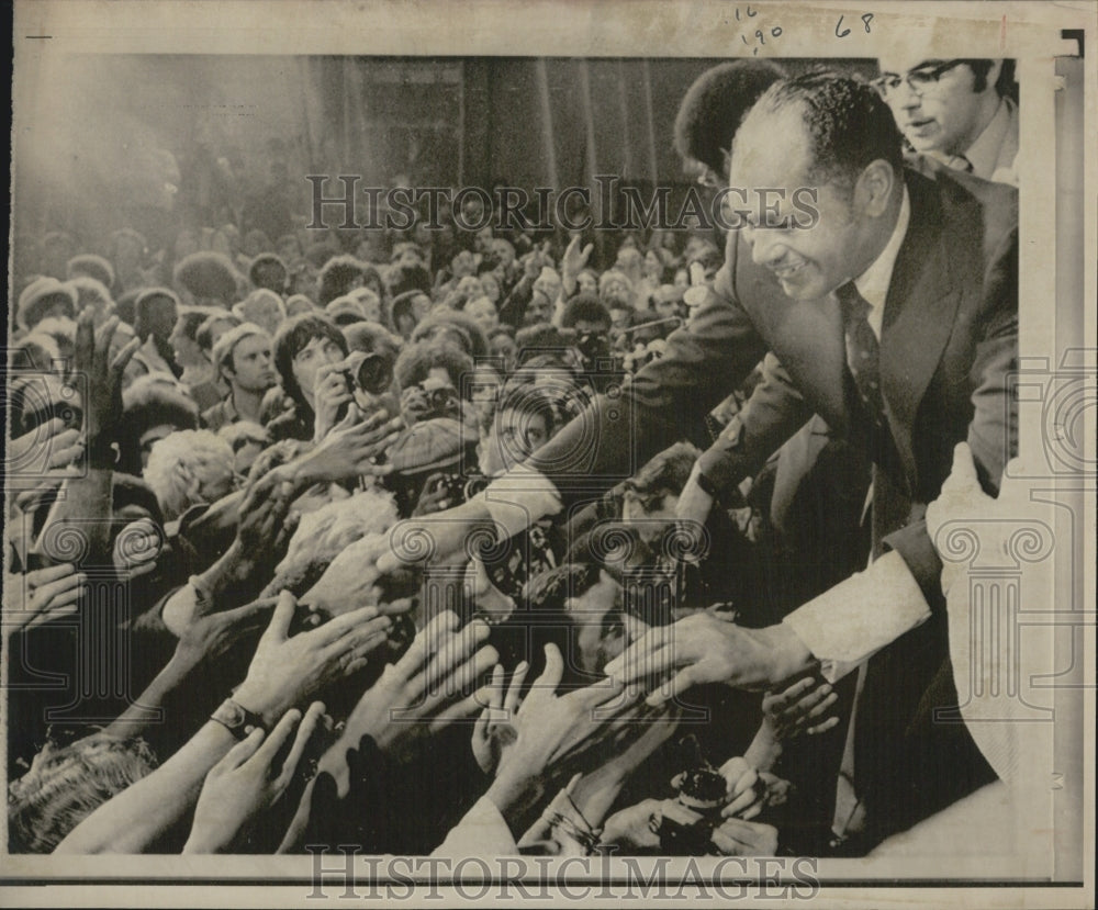 1973 Tom Bradley reaches down to shake hands with crowd supporters - Historic Images