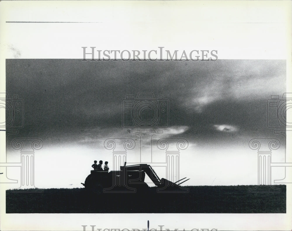 1985 Press Photo David Schroeder takes childern for an evening tractor ride - Historic Images