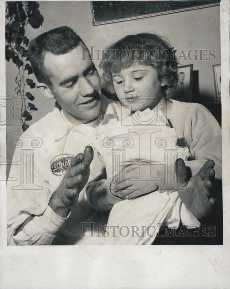 1962 of Harry Stickney showing tot to fold diapers for quadruplets - Historic Images