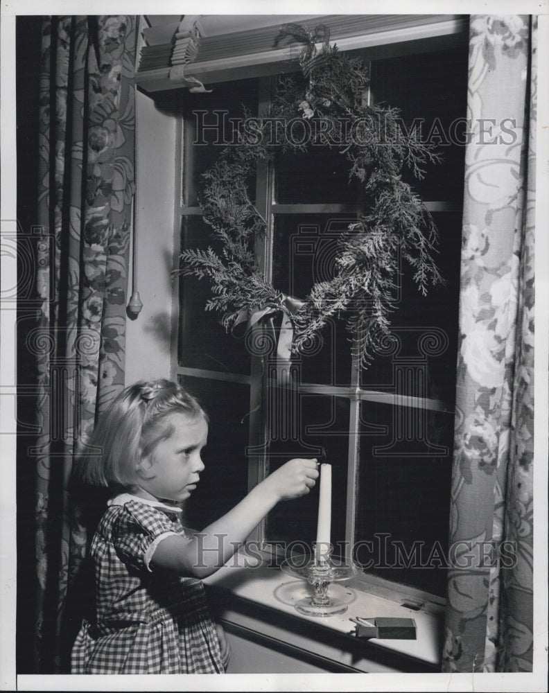 1949 Child Lighting Candle - Historic Images