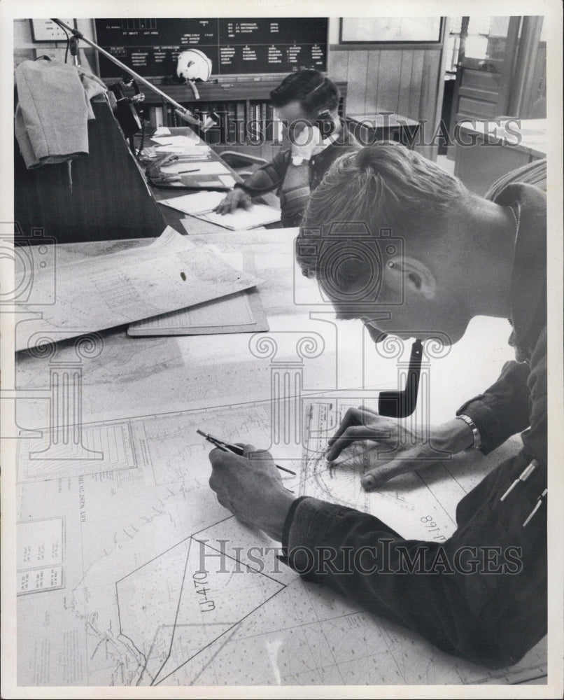 19669 Lt. JG Gene Field, Lt. Cdr. Ken Gard, planning rescue mission. - Historic Images