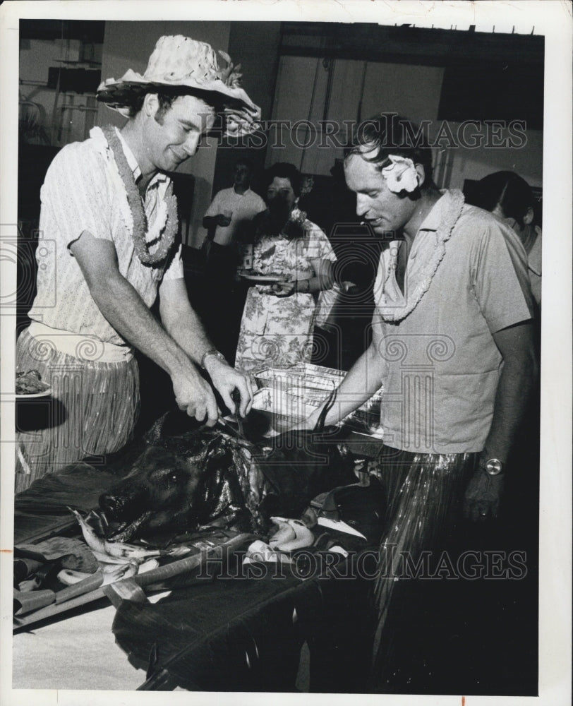 1974 U. S. Coast Guardsman and British sailors fry ham at luau - Historic Images