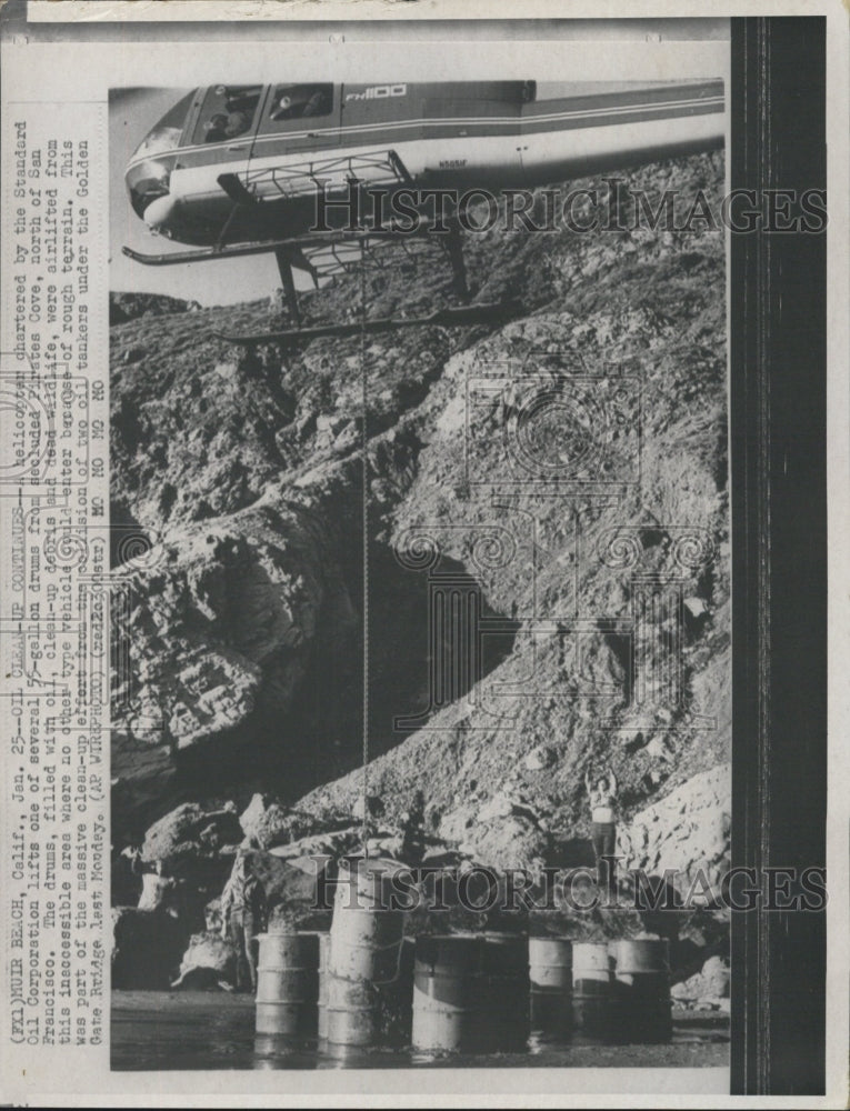 Press Photo helicopter chartered Standard Oil 55 gallon drums oil - Historic Images