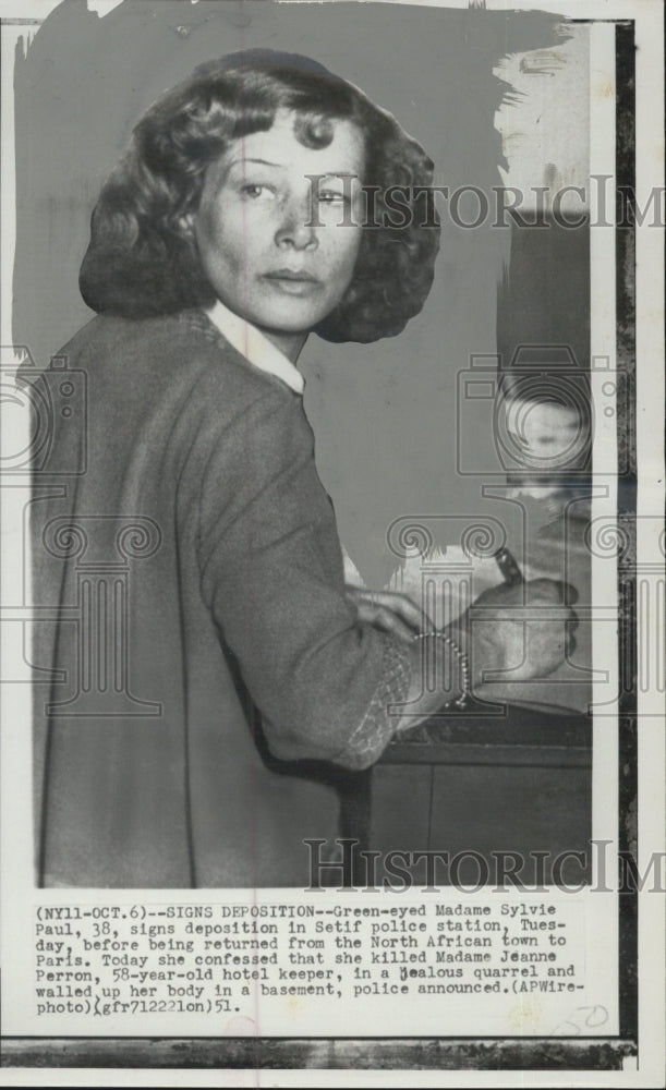 1951 Press Photo Madame Sylvie Paul signs a deposition in police station. - Historic Images