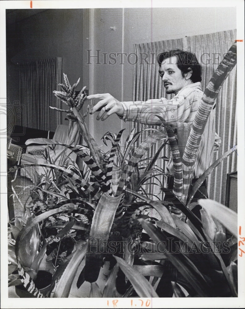 1975 Rick Paul pointing at a flower in the dunedin garden club - Historic Images