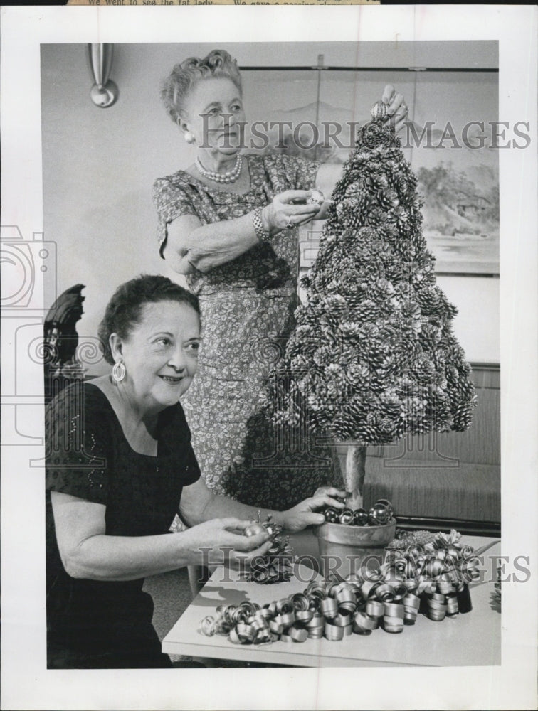 1961 Mrs. Harry Loving, Mrs. Horace Geddes make Christmas tree - Historic Images