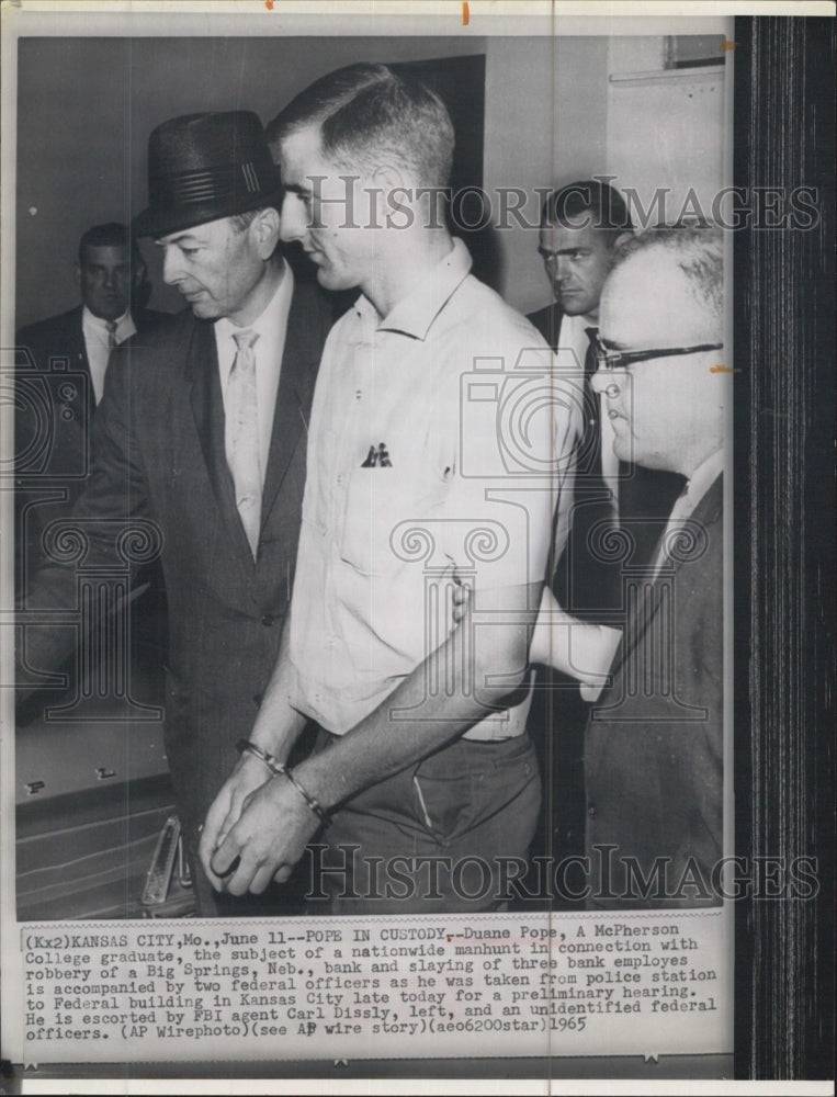 1965 College graduate, Duane Pope escorted by FBI agents after a - Historic Images