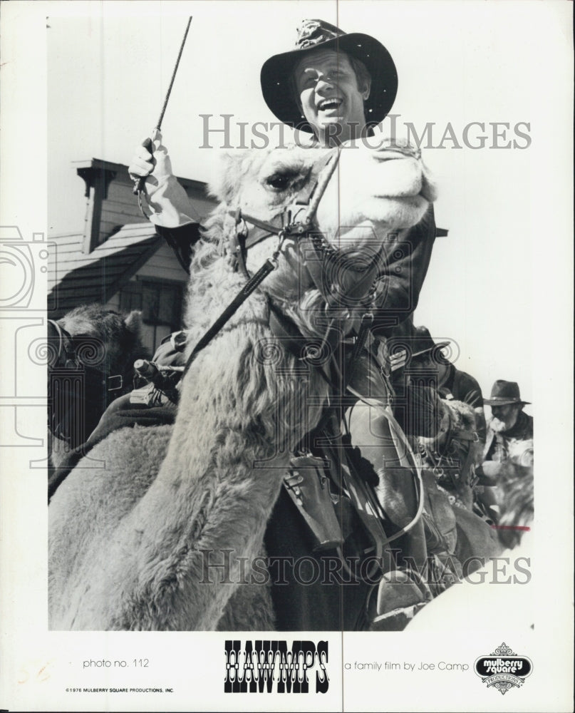 1976 James Hampton plays Lt. Clemmons while riding a camel. - Historic Images