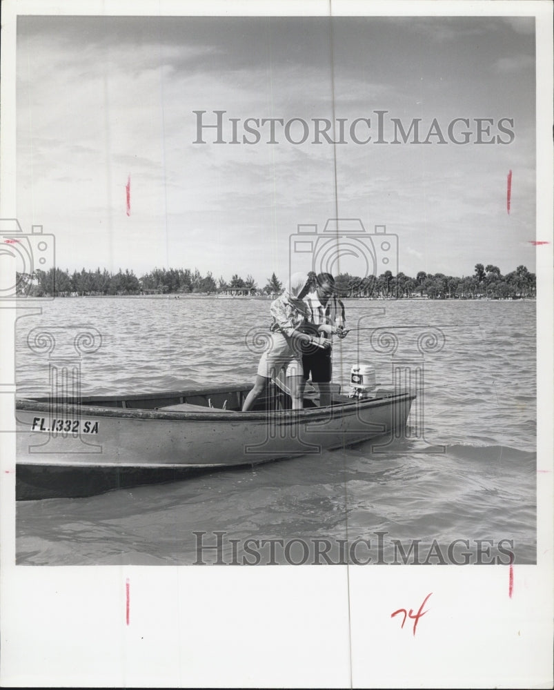 1961 Couple Fishing Off Of Boat - Historic Images