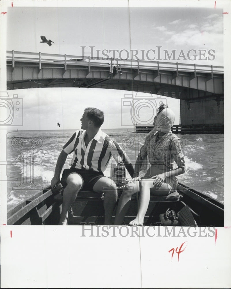 Press Photo Couple On Fishing Boat Watching Bird Fly By - Historic Images