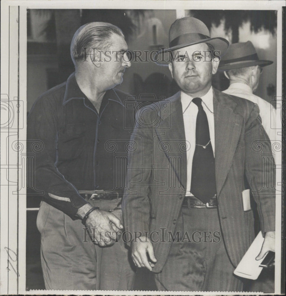 1951 Ernesto Diaz (L) arrestedfor tax stamp law & Deputy M Price - Historic Images