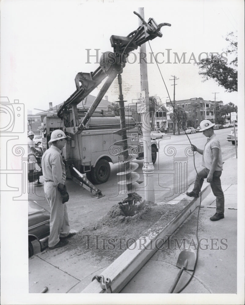 1967 of workers digging a hole for utility pole - Historic Images