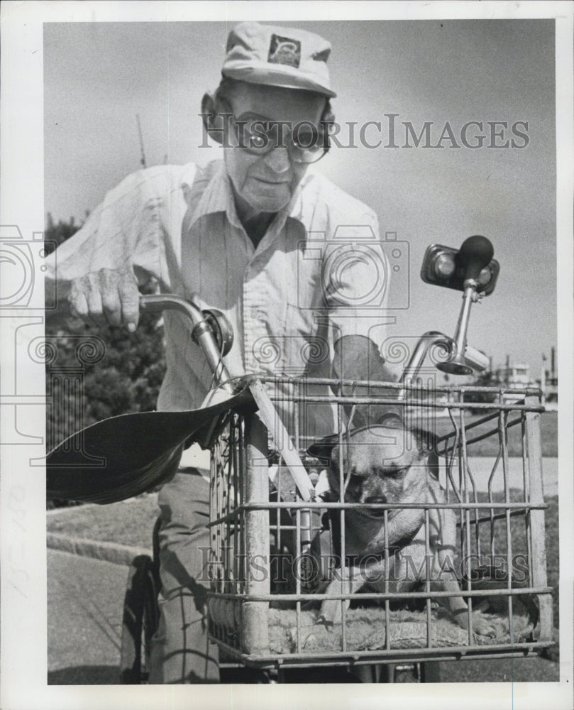 1977 Ralph Madsen is heading home with his fishing buddy. - Historic Images