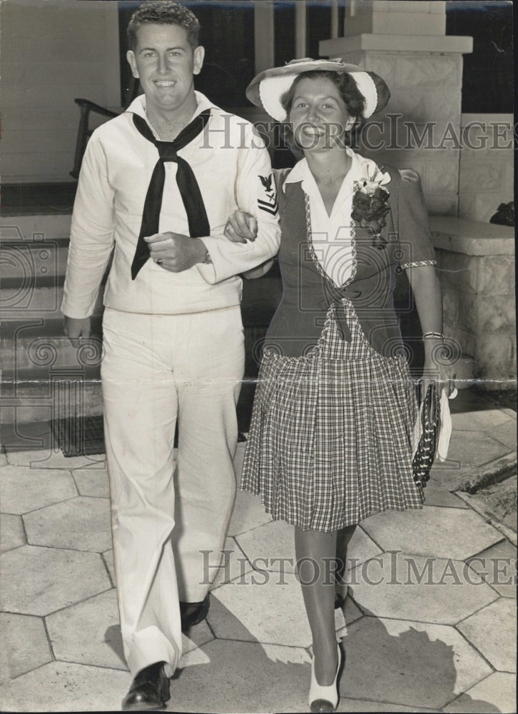 1942 A lady escorted by the man. - Historic Images