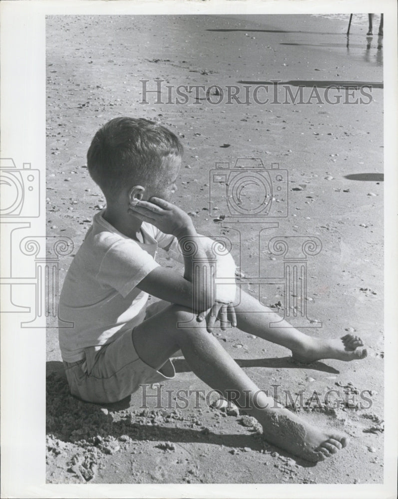 1965 Press Photo Neal Mooney Sits On The Beach - RSG68223 - Historic Images