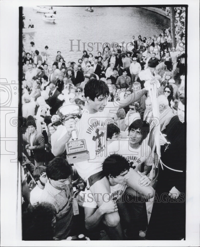 1984 Press Photo Tony Grigoris carried way after receiving Epiphany cross - Historic Images