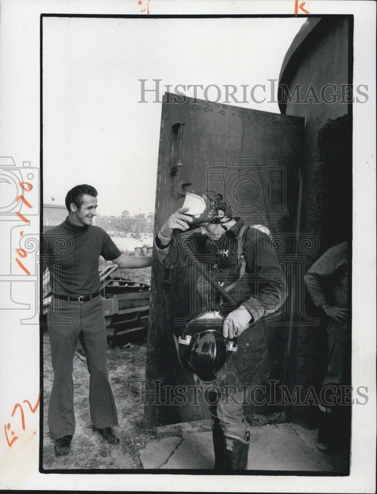 1974 New Port Richey Fire Dept.trainee is guided into test chamber. - Historic Images