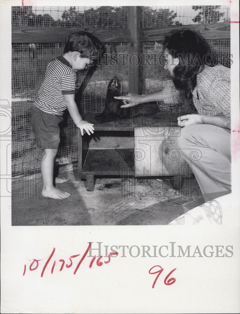 1971 Mother and son with a sea lion. - Historic Images