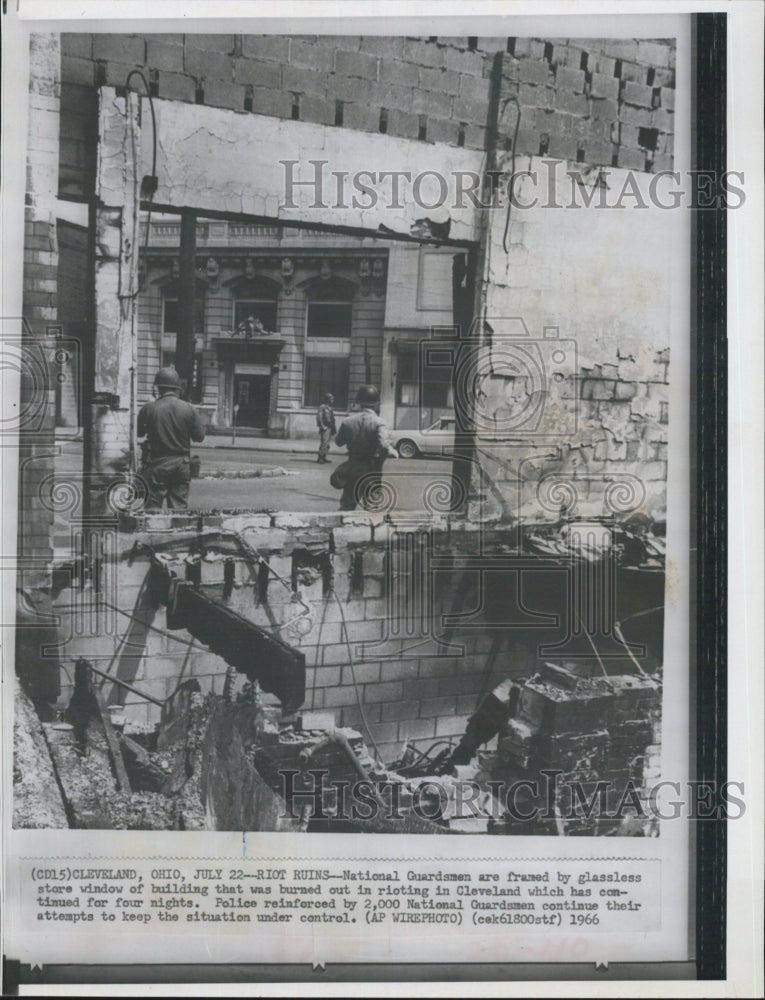 1966 Cleveland OH, Natl. Guardsmen are framed by burned out store - Historic Images