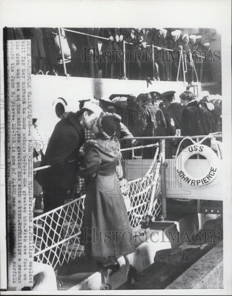 1952 Mrs John Phillips greets husband with a kiss - Historic Images