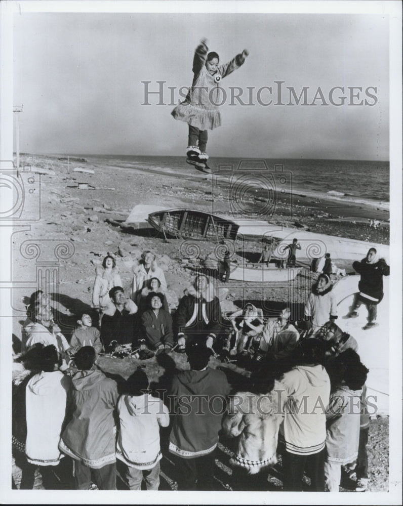 Press Photo Young Eskimo girl flies high on the trampoline - Historic Images