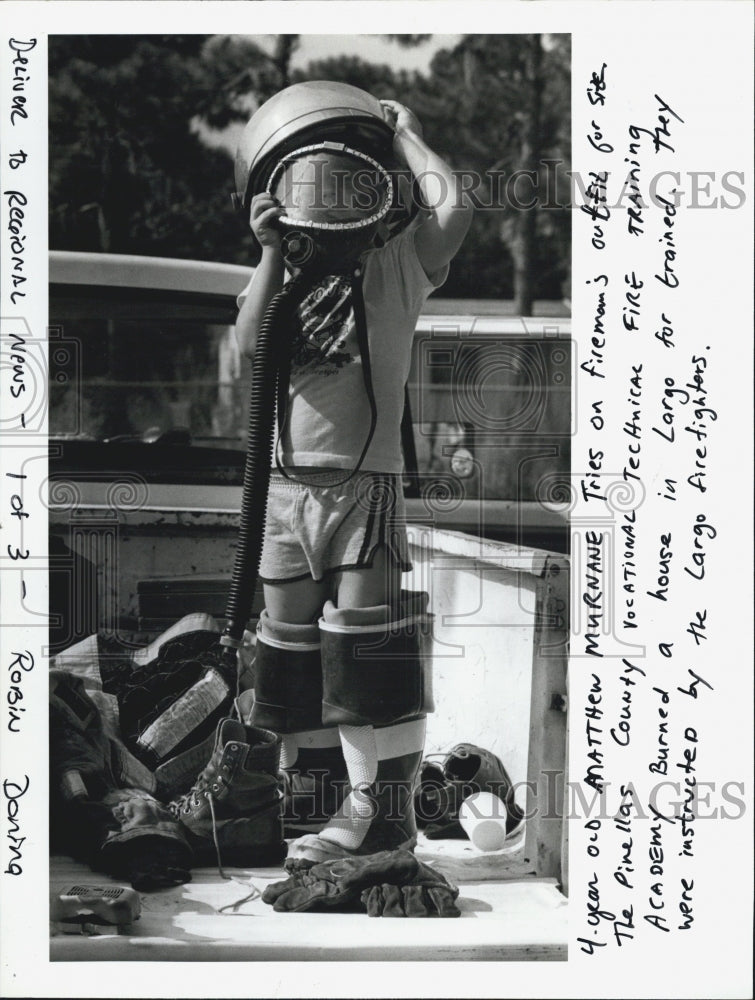 1987 Press Photo Matthew Murnane 4,tries on a Firefighter&#39;s outfit. - Historic Images