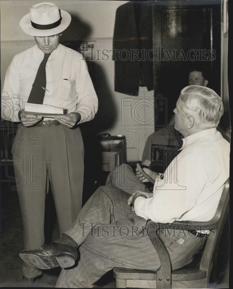 1949 Press Photo Fred Reagan as he relaxes in a wooden chair. - RSG75327 - Historic Images