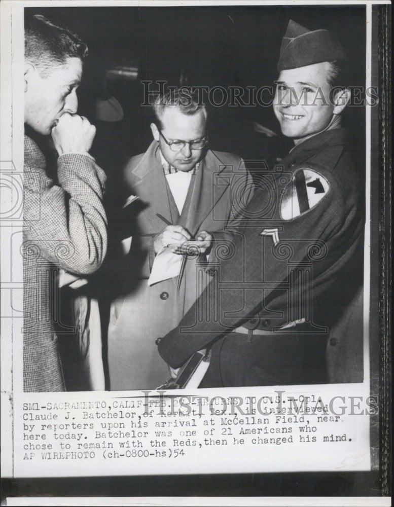 1954 Cpl.Claude Batchelor interview by reporters at McCellan Field. - Historic Images