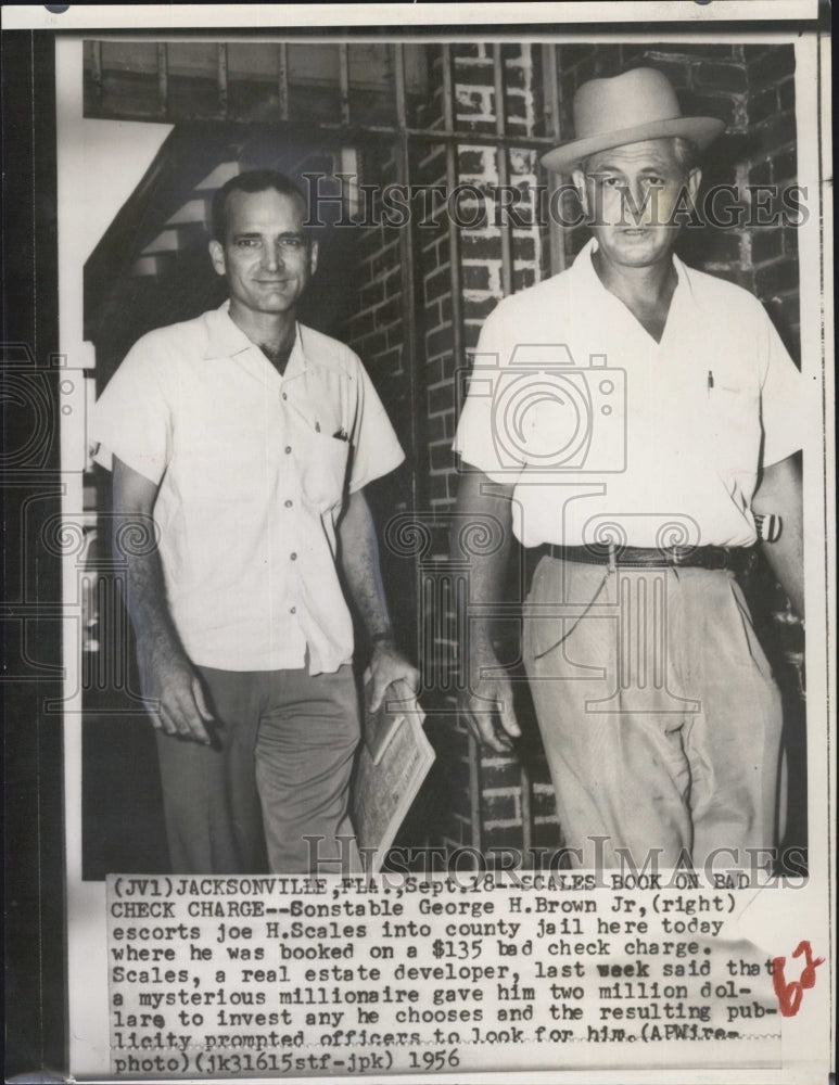 1956 George H. Brown Jr. escorts Joe H. Scales into county jail - Historic Images