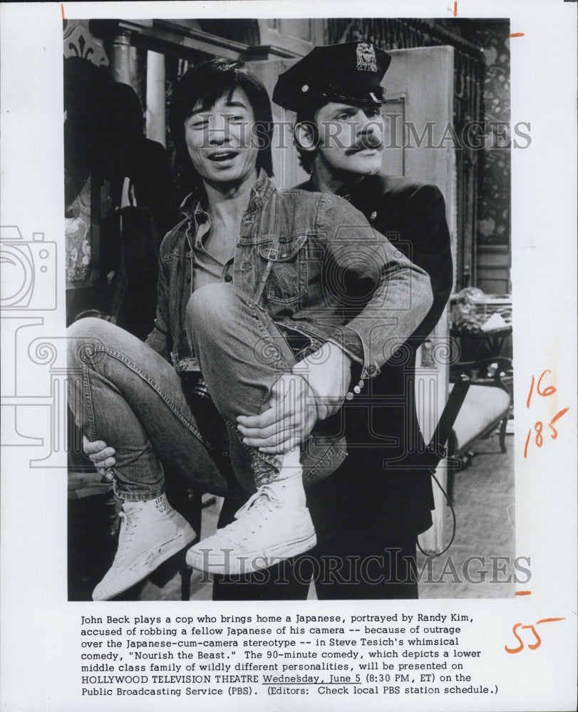 Press Photo Actor John Beck plays a cop carry Japanese Actor Randy Kim. - Historic Images
