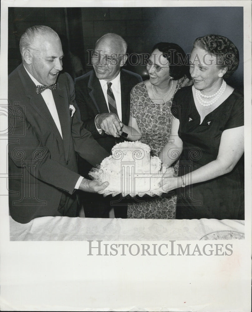 1957 Mr.and rs. Floyd Eady cut the cake during farewell reception - Historic Images