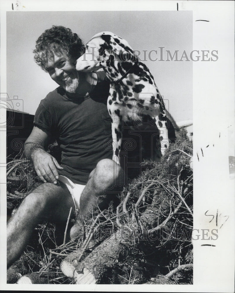 1978 Press Photo Ed Swartz sits atop a pile of Christmas trees - Historic Images