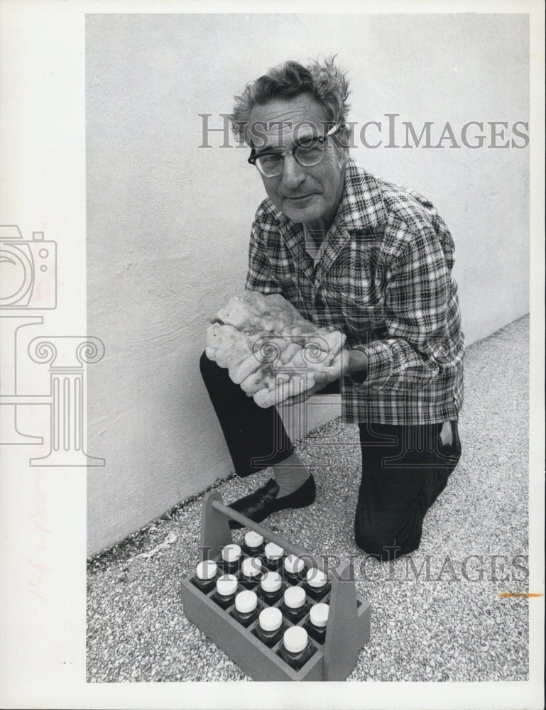 1973 Press Photo A water sample technician holds a sample exuded from a whale. - Historic Images