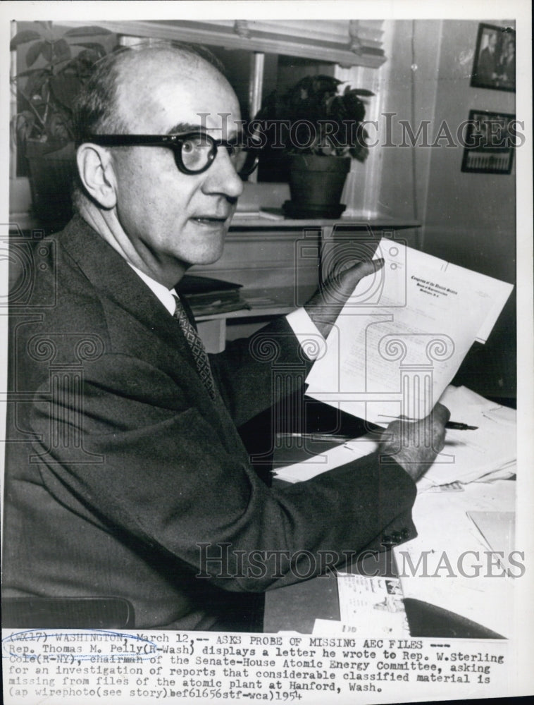 1954 Rep. Thomas M. Pelly at desk displaying letter he wrote - Historic Images