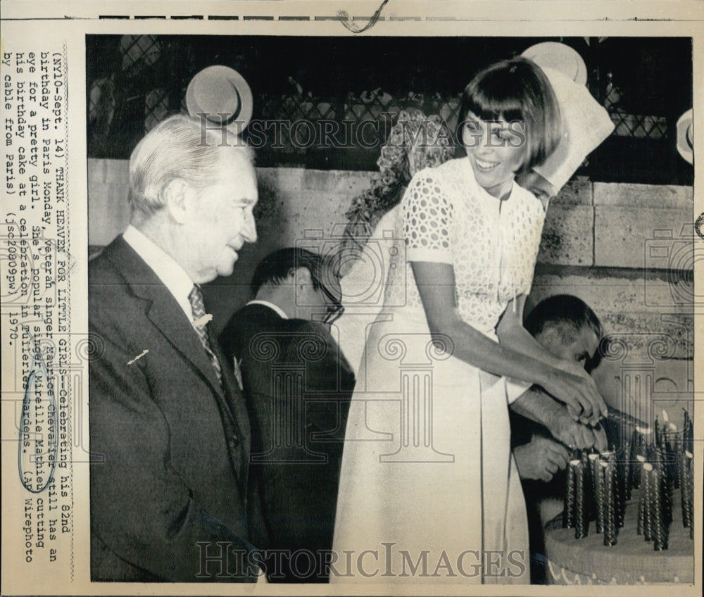 1970 Mireille Mathieu Lights Candles On Cake of Maurice Chevalier - Historic Images