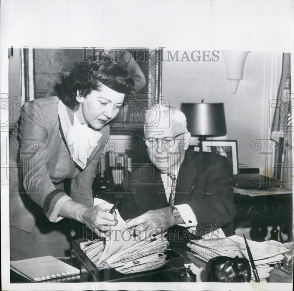 1956 Charles Wilson faces a pile of accumulated paperwork - Historic Images