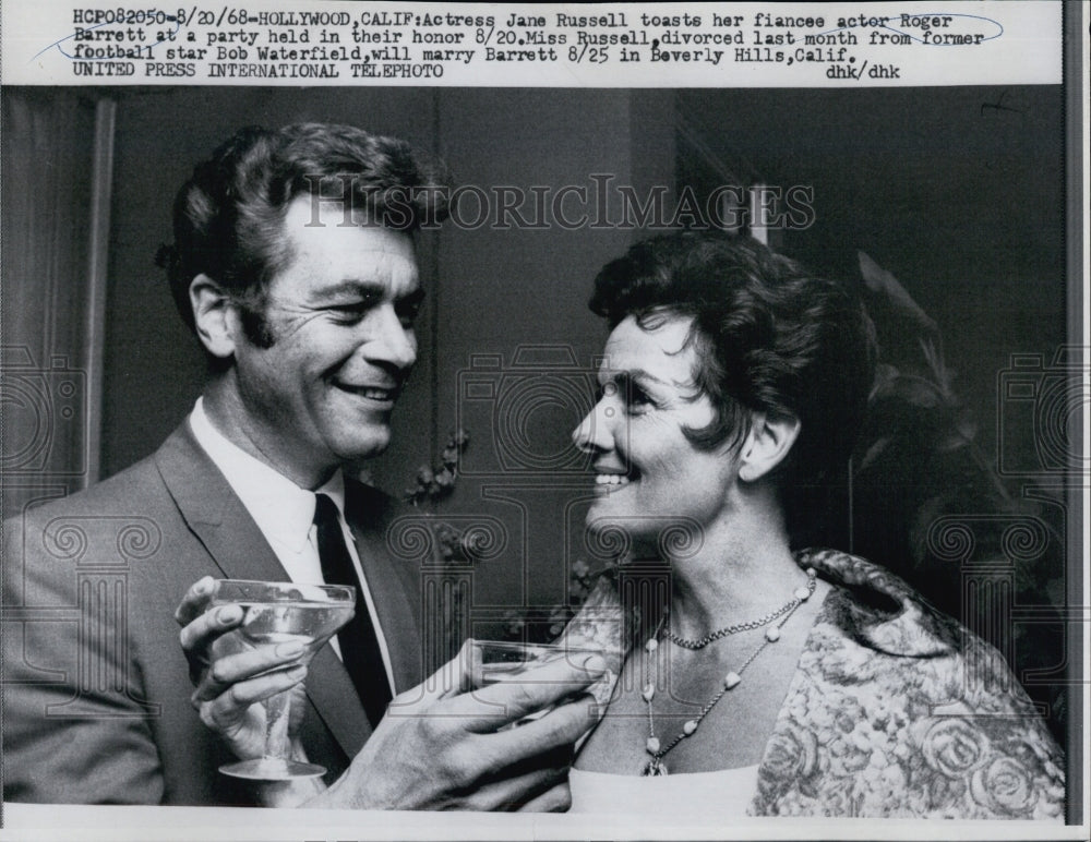 1968 Jane Russell toasts fiancee actor Roger Barrett - Historic Images