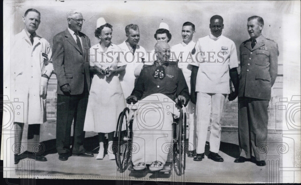 1955 President Eisenhower sits in a wheelchair on the terrace - Historic Images