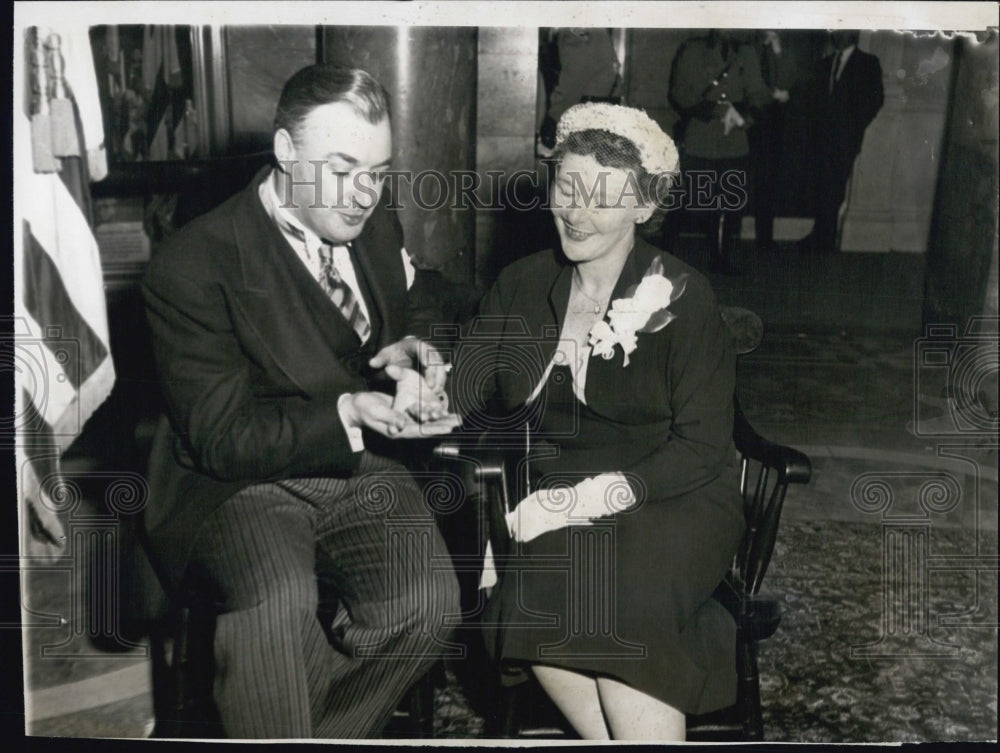 1953 Lt. Gov. Sumner Whittier massaging Mrs. Whittier&#39;s hand - Historic Images