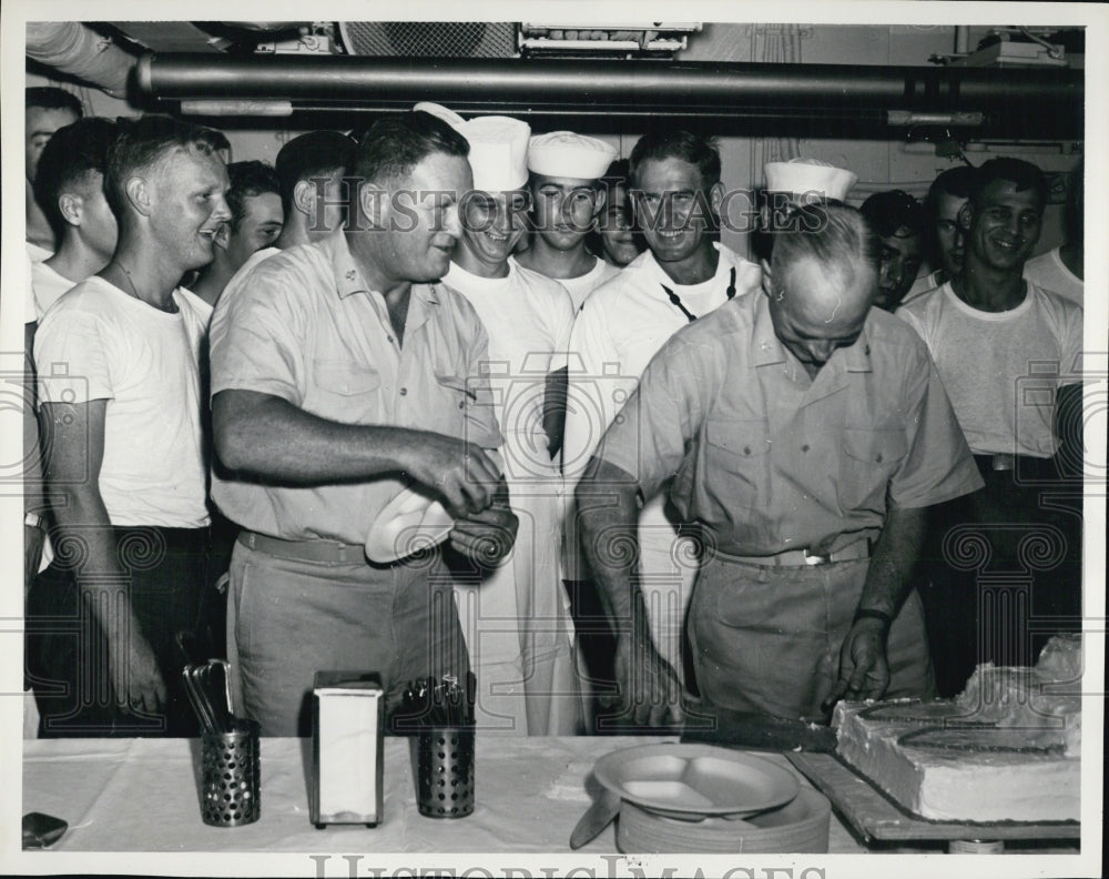 1960 USN Capt. R.T. Whitaker cuts heavy cruiser's birthday cake - Historic Images