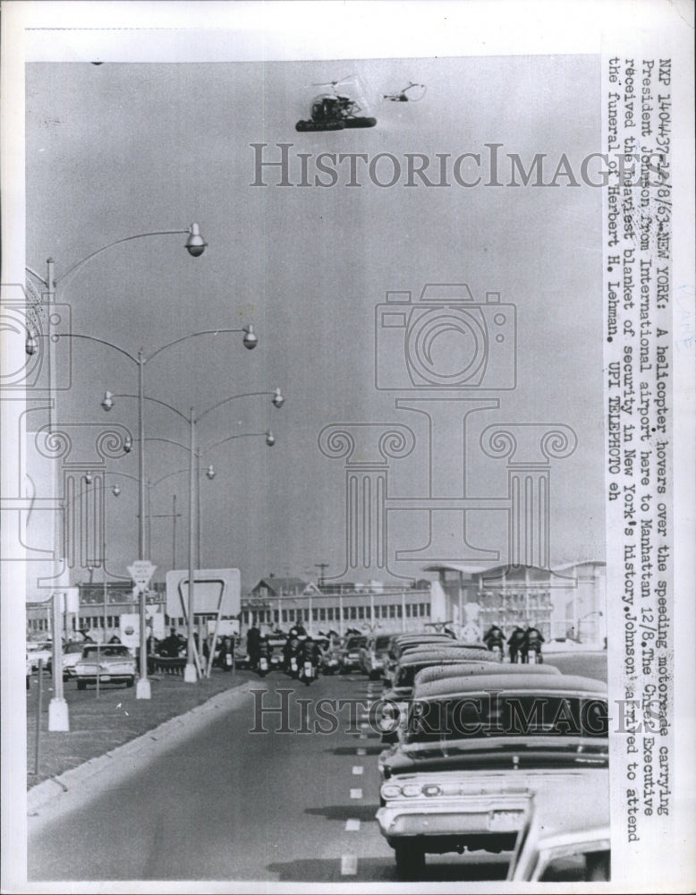 1963 Press Photo A Helicopter Hovers Over the Speeding Motormade Car - Historic Images