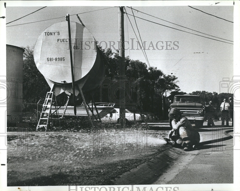 1980 Press Photo Firefighters Hose Off Ground After Tony&#39;s Fuel Oil Truck Spill - Historic Images