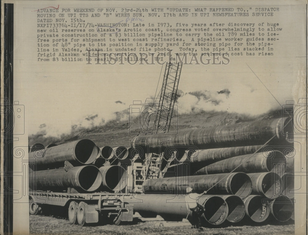 1974 Press Photo A crane stacks pipe for use in the Trans-Alaska Pipeline - Historic Images