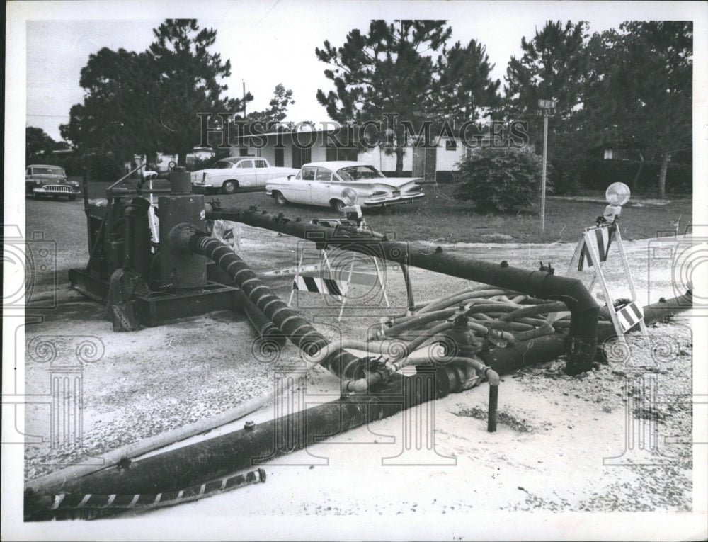 1969 Press Photo Charles P. Barbieri deals with noise from well point pump. - Historic Images