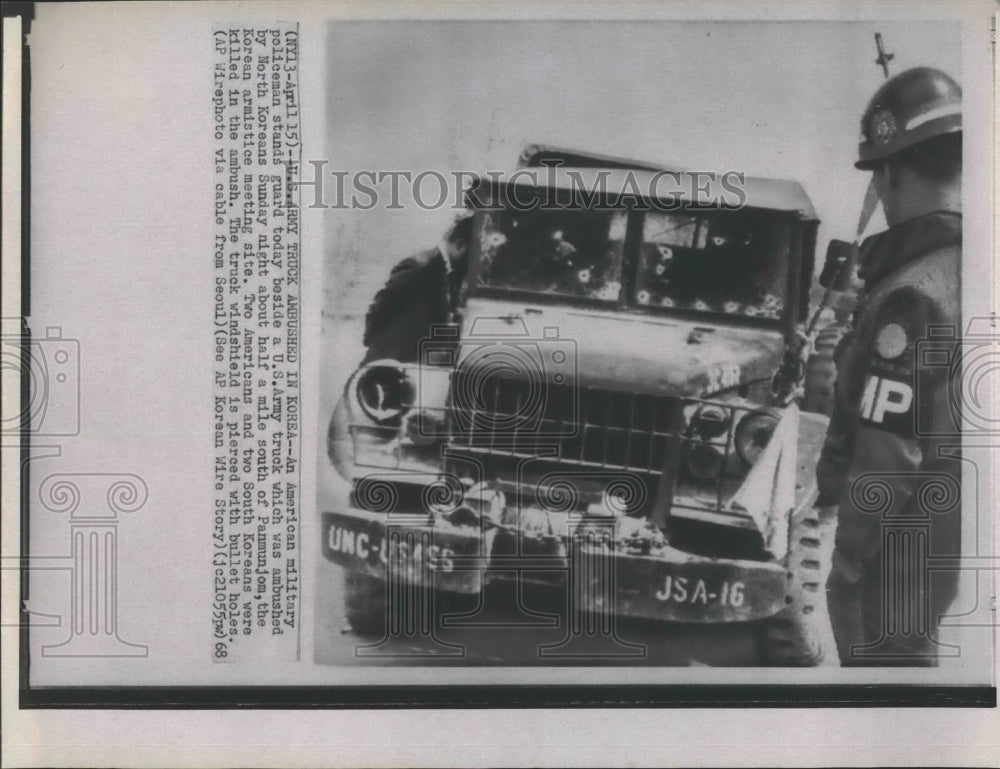 1968 Press Photo Guard stands beside a US army truck which was ambushed . - Historic Images