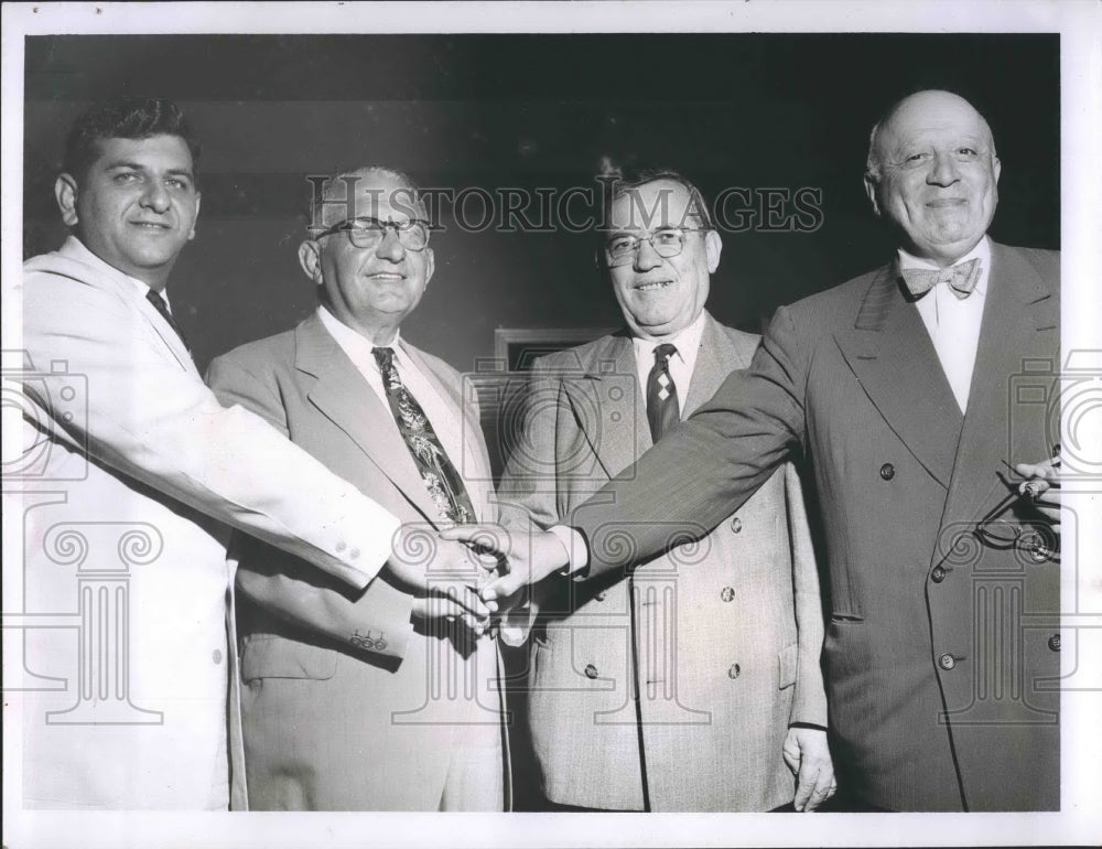 Press Photo Four Men put their hands together - RSH19329 - Historic Images