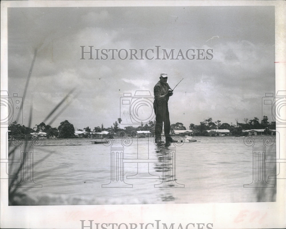 1967PressPhoto John Straitiff is really standing on a dock fishing at high tide - Historic Images