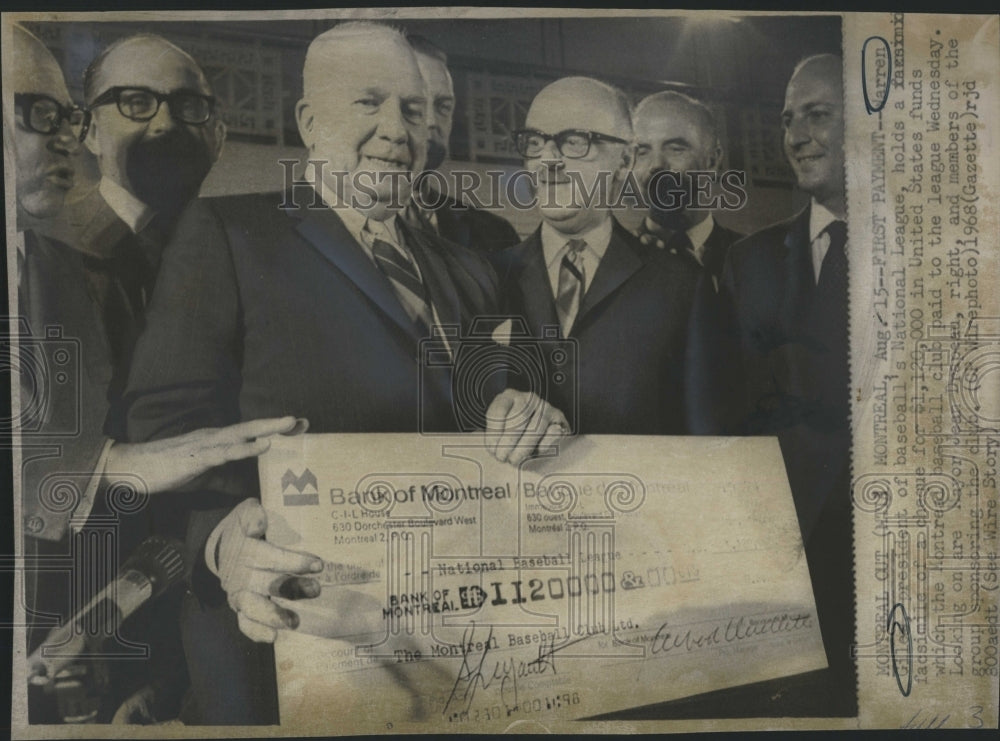 1968 Press Photo Warren Giles holds fax of cheque for $1,120,000 - Historic Images