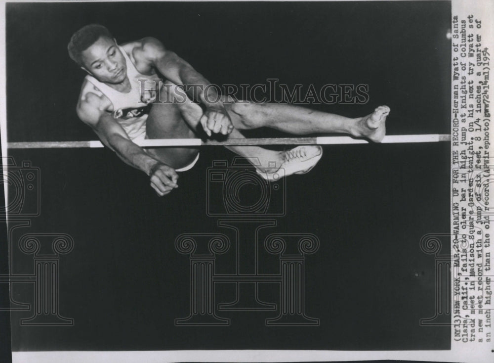 1954 Press Photo Herman Wyatt fails to clear bar in high jump - Historic Images