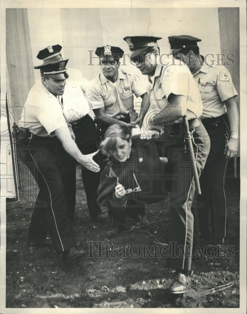 1963 Press Photo Girl picket holds glasses as she carried off. - Historic Images